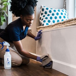 Home-Clean-Heroes-cleaner-wiping-down-baseboards