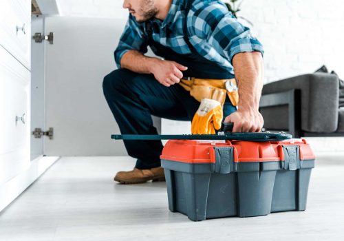 cropped-view-of-bearded-handyman-sitting-and-holding-toolbox.jpg