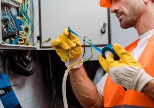 cropped-view-of-electrician-using-insulating-tape-while-fixing-wires-of-electric-panel.jpg