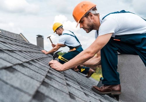 selective-focus-of-handsome-handyman-repairing-roof-with-coworker.jpg